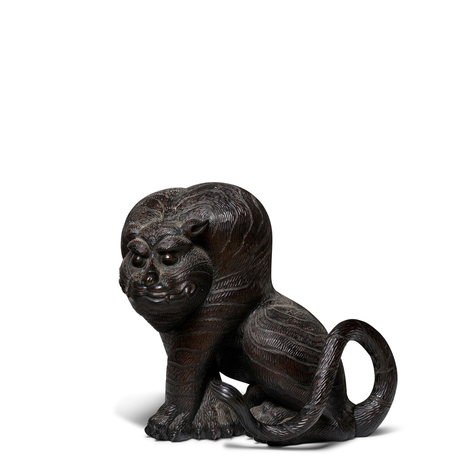 A MASSIVE WOOD MODEL OF A TIGER Meiji (1868-1912) or Taisho (1912-1926) era, late 19th/ 20th cen...: A MASSIVE WOOD MODEL OF A TIGER Meiji (1868-1912) or Taisho (1912-1926) era, late 19th/ 20th century Carved from a solid block of wood, with the exception of the tail, as seated tiger with front legs