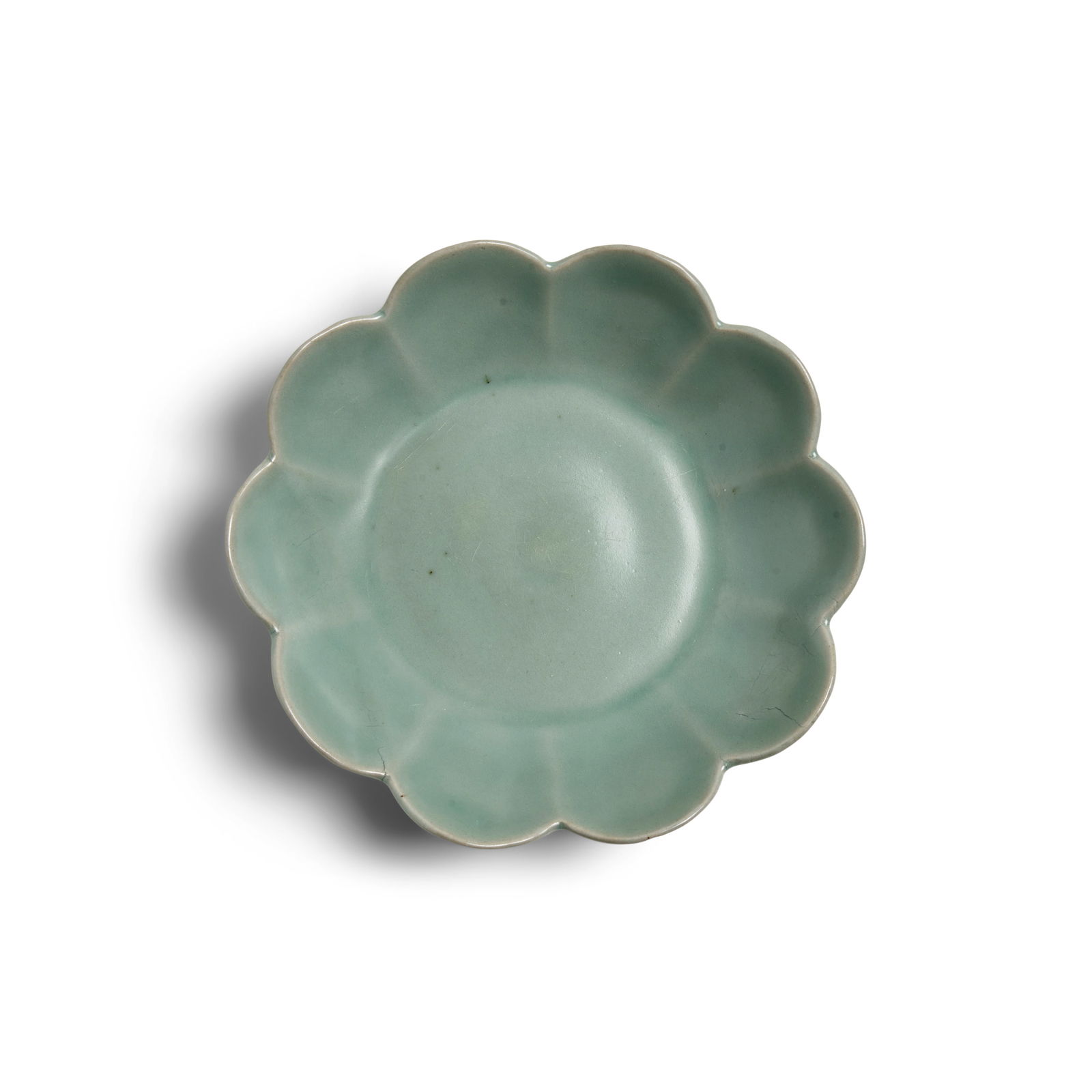 A CHRYSANTHEMUM-FORM CELADON DISH Goryeo Dynasty (918-1392), 12th/13th Century: A CHRYSANTHEMUM-FORM CELADON DISH Goryeo Dynasty (918-1392), 12th/13th Century Molded in the form of a ten-lobed chrysanthemum blossom, the glazed foot with three spur marks, covered in a blueish-gree