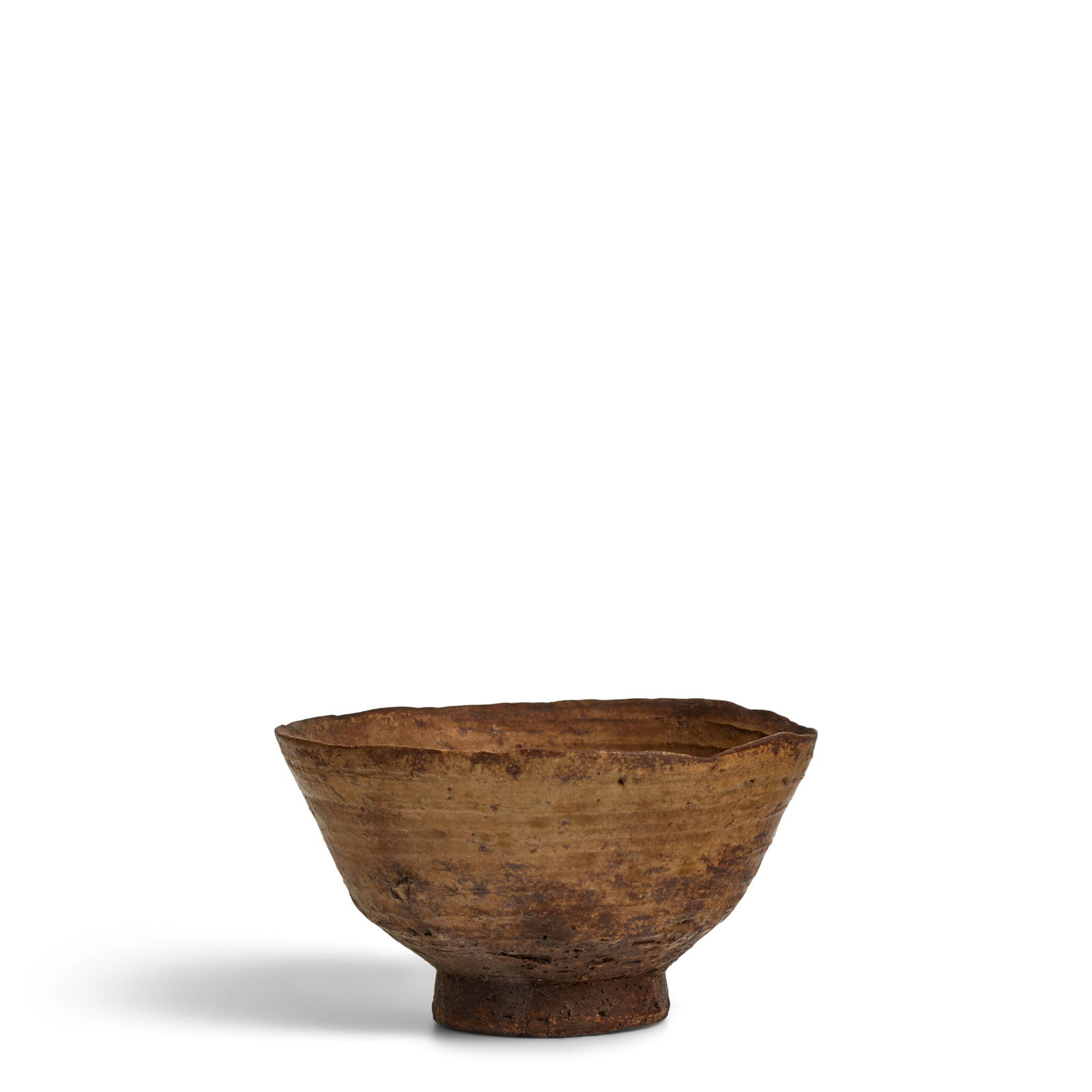 A 'KI-IRABO' TYPE TEA BOWL Joseon dynasty (1392-1897), 17th/18th century: A 'KI-IRABO' TYPE TEA BOWL Joseon dynasty (1392-1897), 17th/18th century Wheel-thrown and covered with a mottled dark-mustard yellow glaze, the thin-walled vessel having a slightly rough texture and u