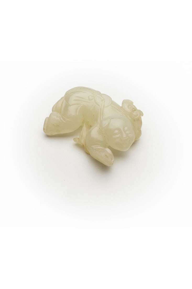 A WHITE JADE ORNAMENT OF A CHILD Qing dynasty: A WHITE JADE ORNAMENT OF A CHILD Qing dynasty with a stand, 4.3cm long, 20g Footnotes: 清 白玉財童小把件 及座 For further information on thi