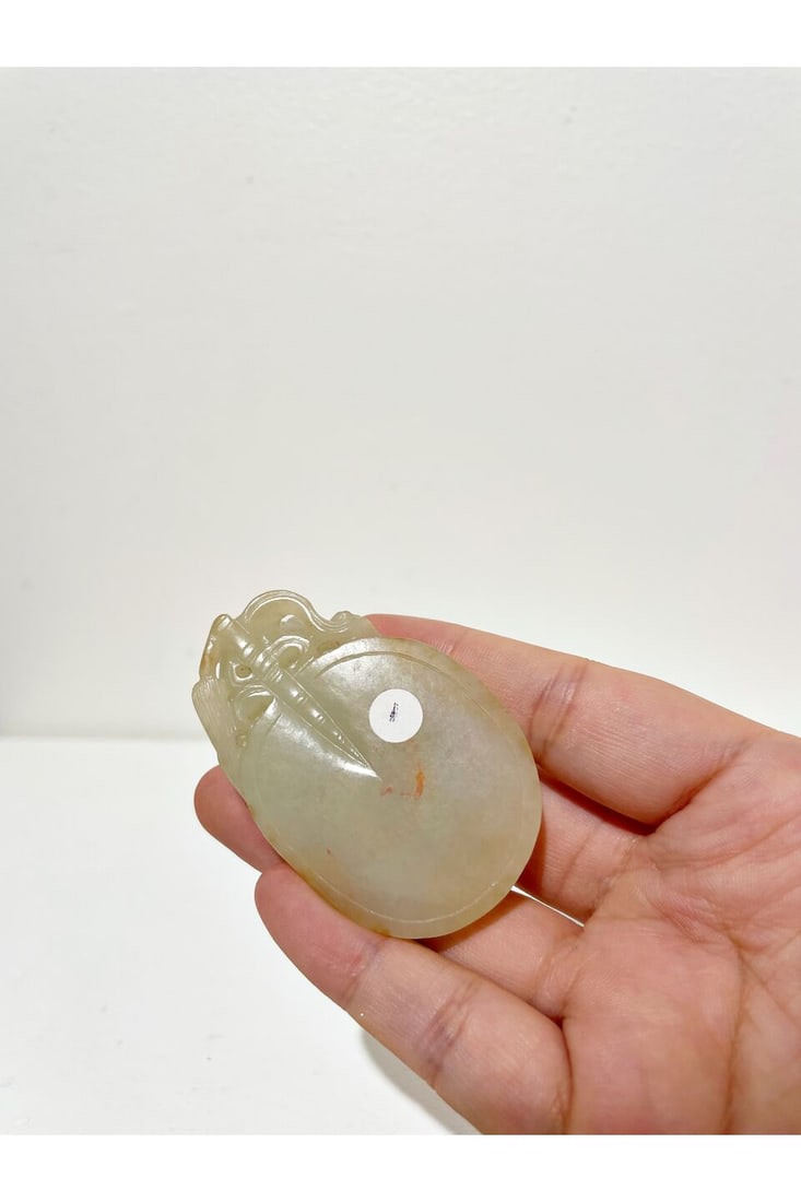 A WHITE JADE CARVING OF TWO BADGERS OVER A ROUNDED FAN 19th century - 2