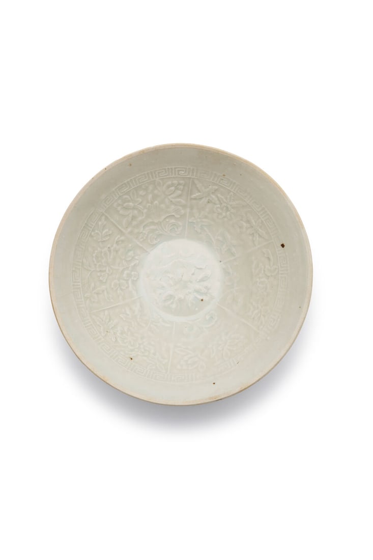 A QINGBAI MOULDED 'PEONY' BOWL 13th century: A QINGBAI MOULDED 'PEONY' BOWL 13th century 19.1cm diam. Footnotes: 十三世紀 青白模印牡丹紋盞 For further information on this