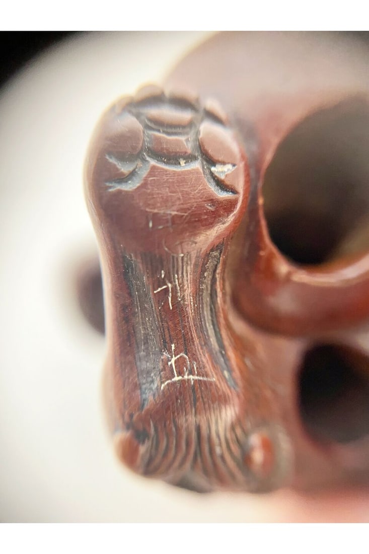 A BOXWOOD NETSUKE OF A SHISHI 19th century - 2