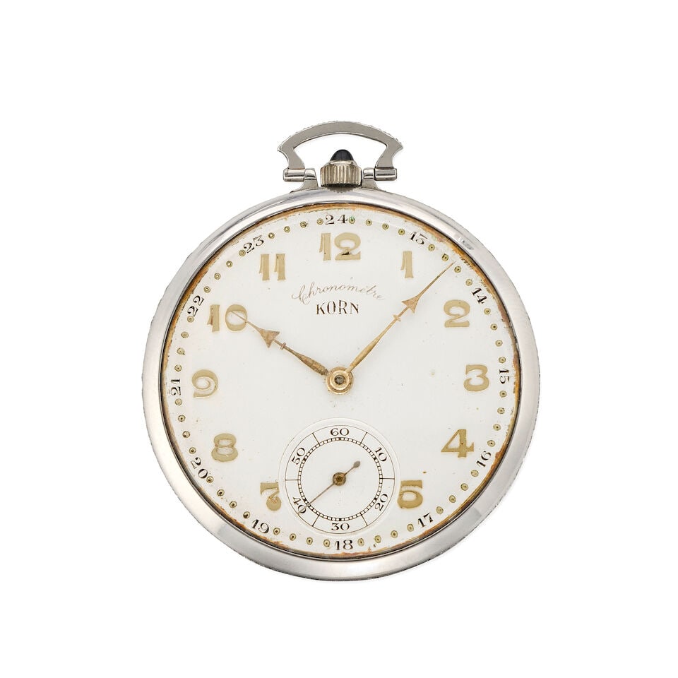 Korn. A platinum and diamond set keyless wind open face pocket watch Circa 1920: Korn. A platinum and diamond set keyless wind open face pocket watch Date: Circa 1920 Movement: Swiss lever Dial: Silvered Case: Polished round, diamond set band and bow Signed: Dial Size: 44mm For