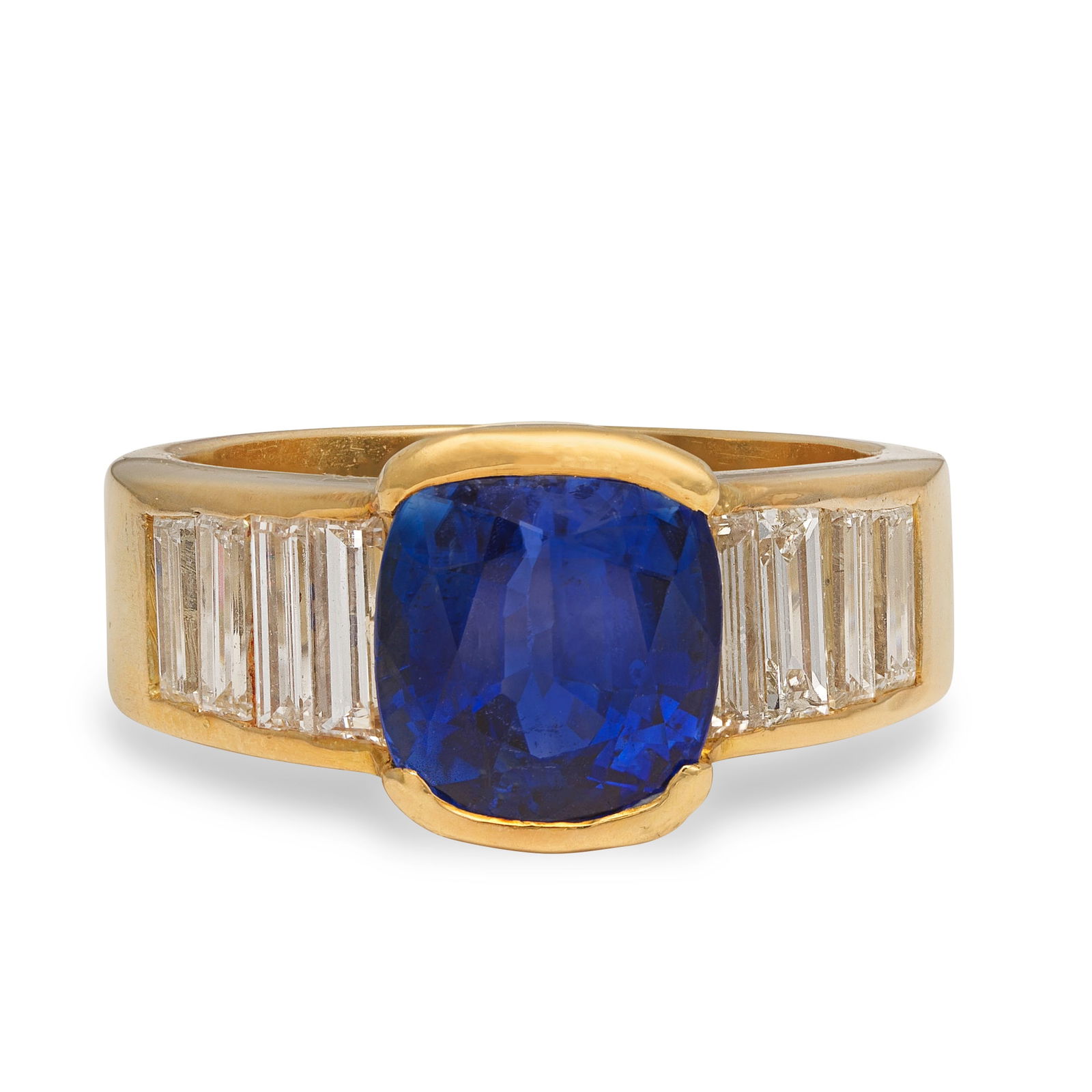 SAPPHIRE AND DIAMOND RING: SAPPHIRE AND DIAMOND RINGThe cushion-shaped sapphire between baguette-cut diamond shoulders, sapphire approx. 3.70cts, diamonds approx. 1.20cts total, ring size approx. L