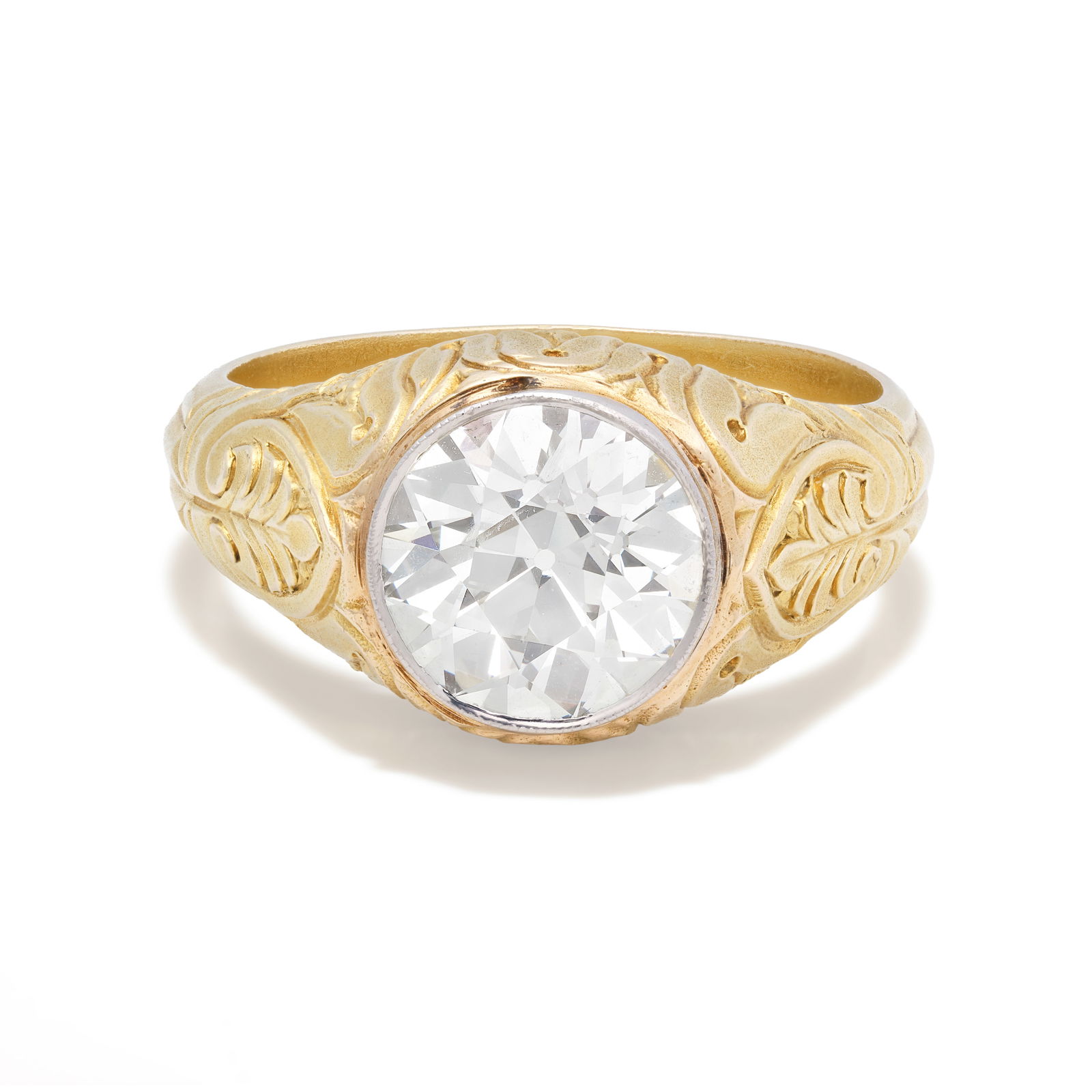 DIAMOND SINGLE-STONE RING: DIAMOND SINGLE-STONE RINGSet with an old brilliant-cut diamond, to an engraved mount of foliate detail, ring size approx. T