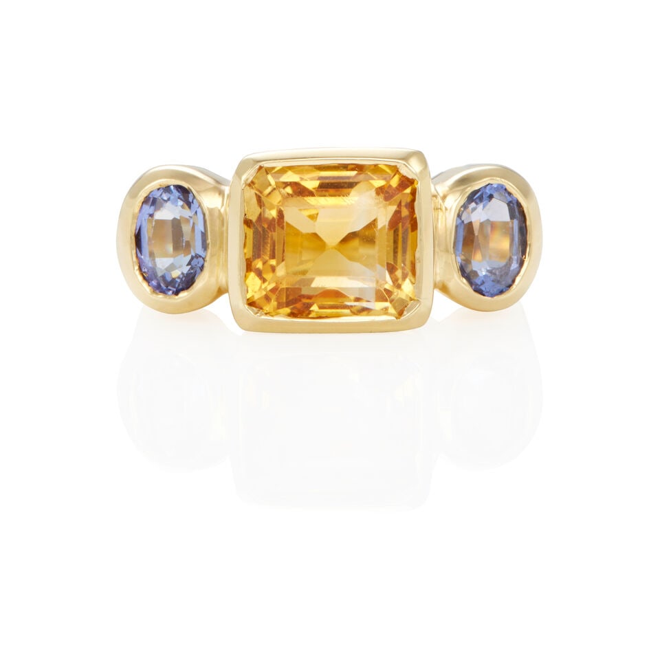 18K GOLD, CITRINE AND TANZANITE RING: 18K GOLD, CITRINE AND TANZANITE RING • 18k yellow gold • 1 rectangular citrine weighing approximately 2.15 - 2.25 carats • 2 oval tanzanites weighing approximately 1.00 - 1.10 carat