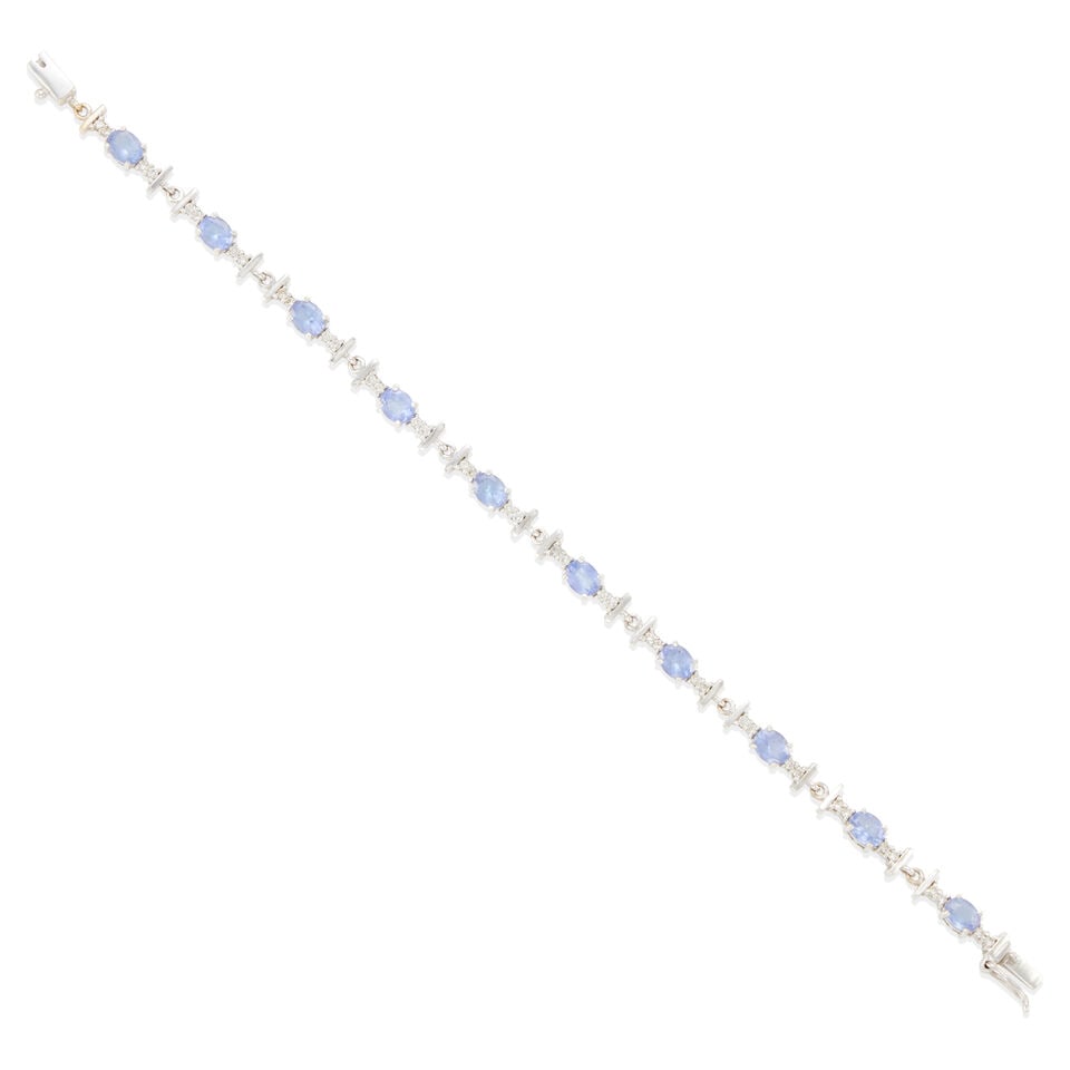 18K WHITE GOLD, TANZANITE, AND DIAMOND BRACELET: 18K WHITE GOLD, TANZANITE, AND DIAMOND BRACELET • 18k white gold • 10 oval tanzanites weighing approximately 4.00 carats total • Numerous round diamonds weighing approximately 0.35