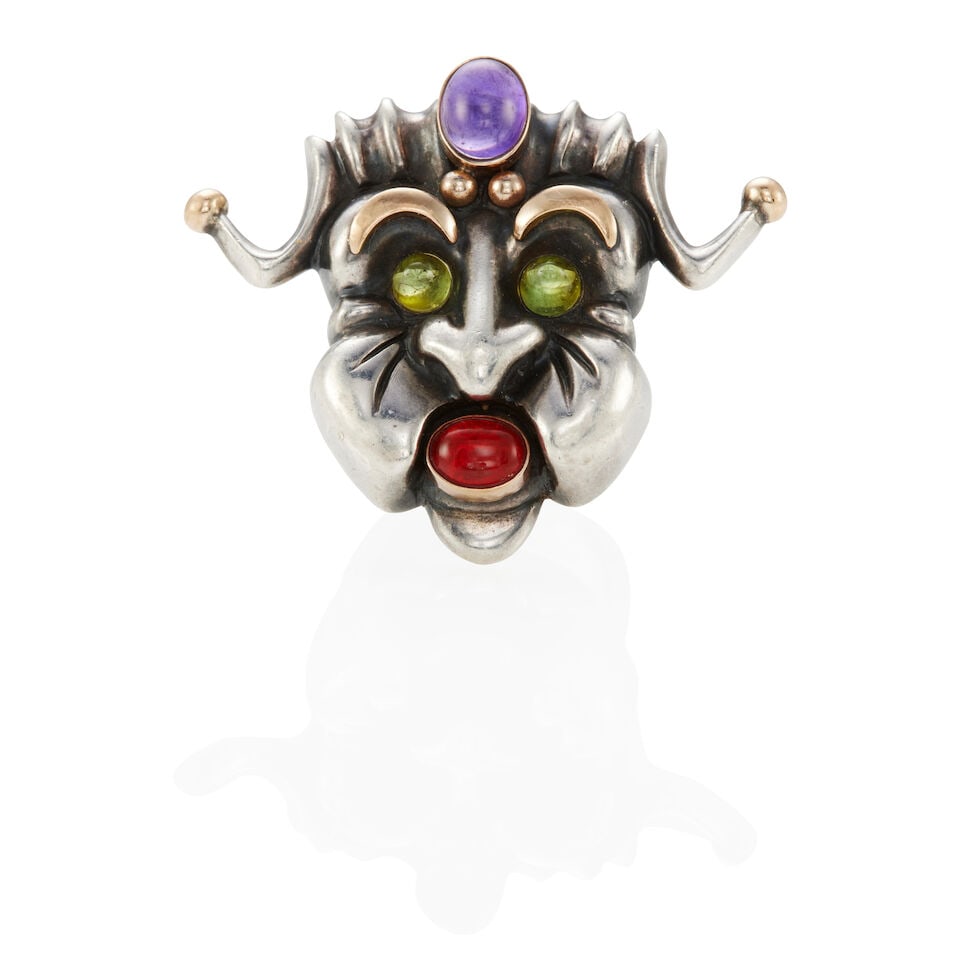 F.J. COOPER: STERLING SILVER, 14K GOLD, AND GEM-SET MASK RING: F.J. COOPER: STERLING SILVER, 14K GOLD, AND GEM-SET MASK RING • Sterling silver and 14k yellow gold • 1 oval cabochon amethyst weighing approximately 2.15 - 2.20 carats total (9.49 x 7.40