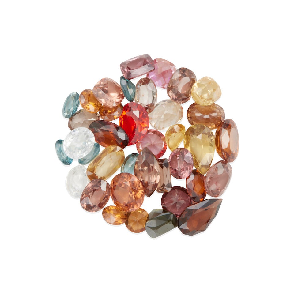 GROUP OF LOOSE ZIRCONS AND COLORED GEMSTONES: GROUP OF LOOSE ZIRCONS AND COLORED GEMSTONES • Numerous zircons of various shapes and sizes weighing approximately 64.94 carats total Footnotes: Please note only a small sample of this lot has
