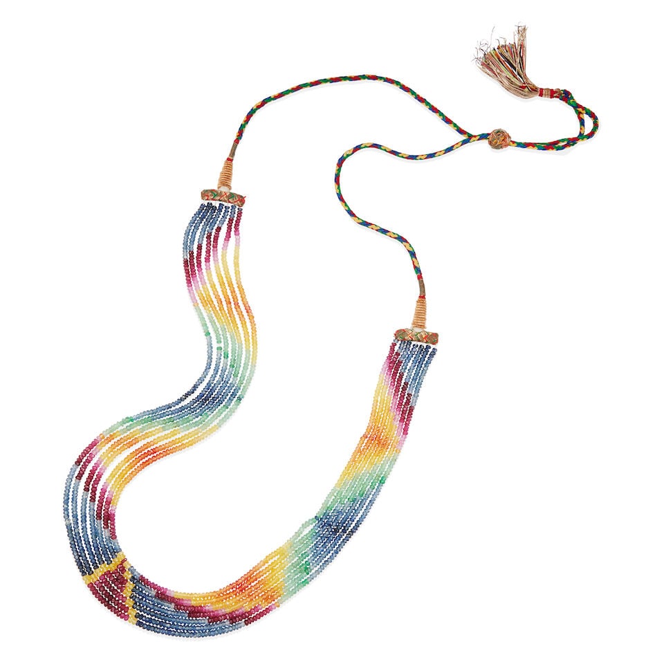 SEVEN STRAND MULTI-STONE FACETED BEAD AND THREAD NECKLACE: SEVEN STRAND MULTI-STONE FACETED BEAD AND THREAD NECKLACE • Woven colorful thread and string • Numerous faceted beads of multi-colored sapphires, rubies and emeralds • Length is
