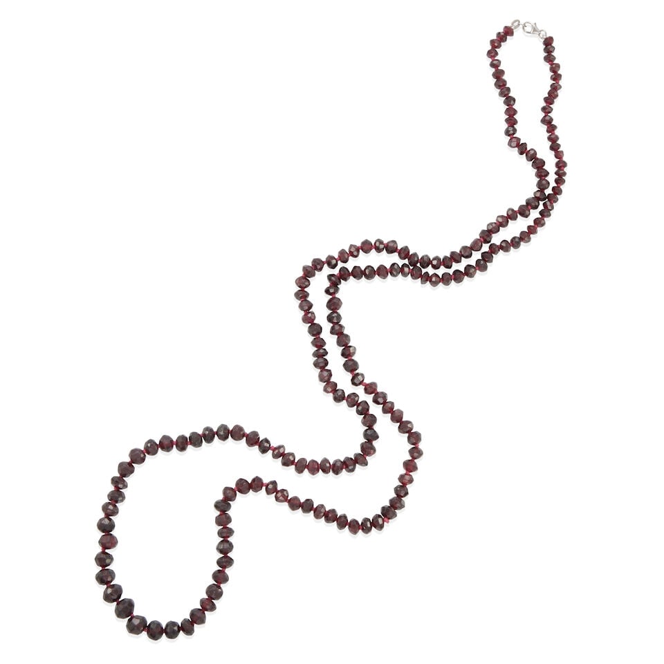 14K GOLD AND GARNET BEAD NECKLACE: 14K GOLD AND GARNET BEAD NECKLACE • 14k white gold clasp • Numerous faceted garnet beads 5.15 - 6.80 mm • Length 34 1/2 • Estimated gross weight: 61.4 grams Footnotes: Overall