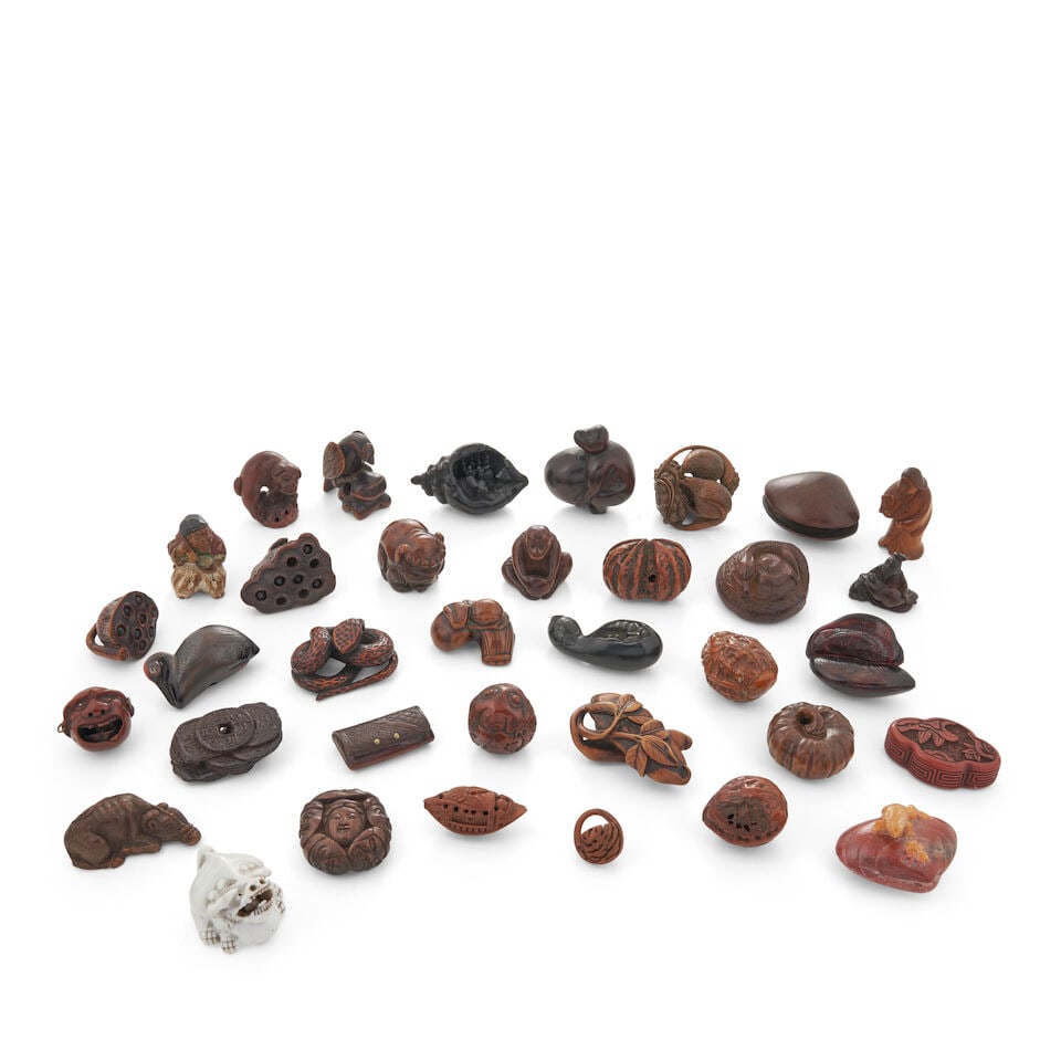 Group of Thirty-Three Wood Netsuke, One Ceramic Netsuke, and One Stone Netsuke, Japan,: Group of Thirty-Three Wood Netsuke, One Ceramic Netsuke, and One Stone Netsuke, Japan, Arranged in rows from top to bottom, the first row from left to right comprising: a dog figure, signed Toyomasa; 