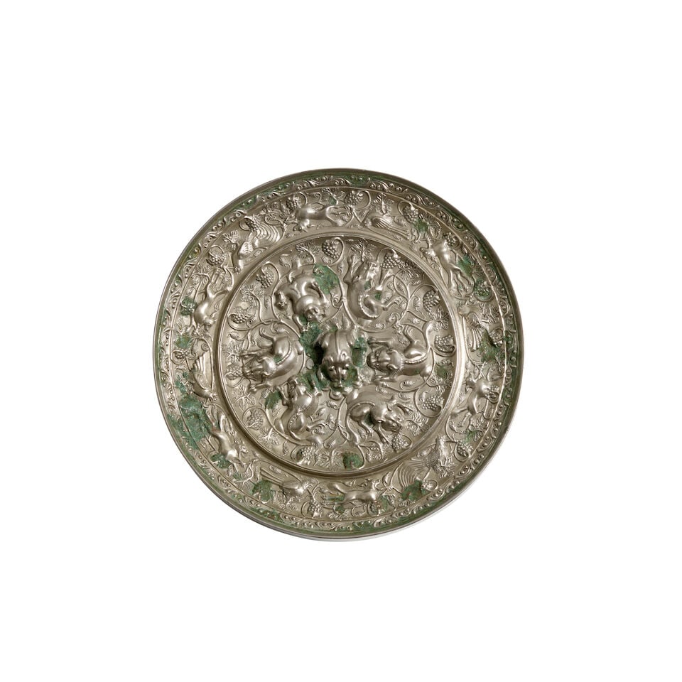 A Silvered Bronze 'Lion and Grapevine' Mirror China, Tang style, (1 of 2)