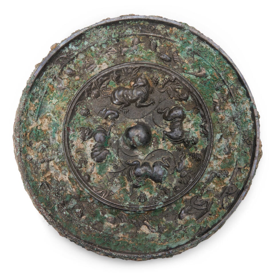 A Bronze Mirror, 'Lion and Grapevine' Motif China, Tang style, (1 of 2)