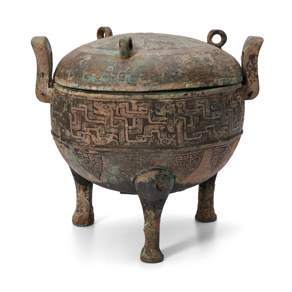 A Bronze Tripod Vessel and Cover, Ding China, Warring States style,: A Bronze Tripod Vessel and Cover, Ding China, Warring States style, 9 1/2in (24.1cm) high; 10 1/8in (25.6cm) across Lot to be sold without reserve. This lot is subject to the following lot symbols: &#