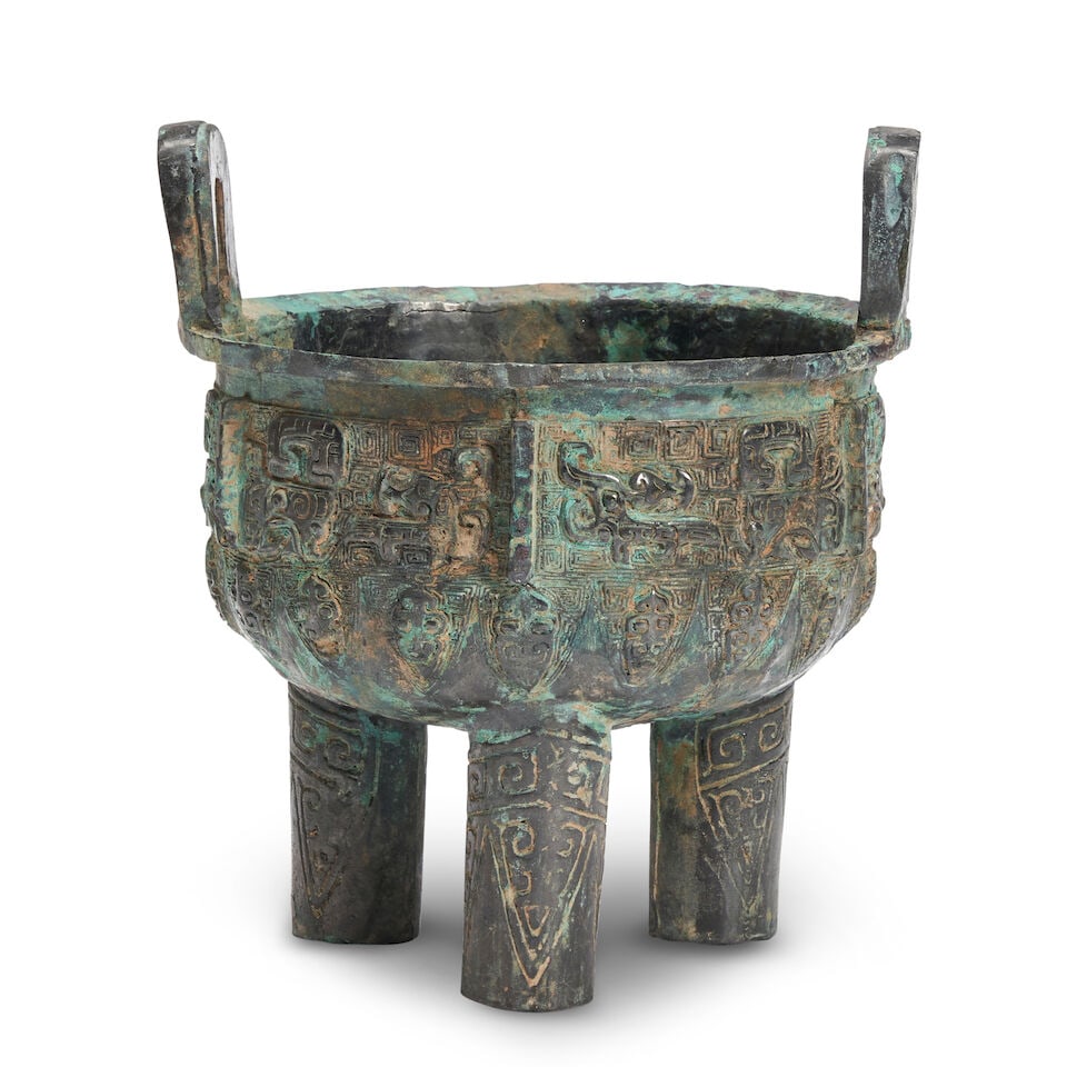 A Bronze Tripod Food Vessel, Ding China, Shang style,: A Bronze Tripod Food Vessel, Ding China, Shang style, 8in (20.3cm) across Lot to be sold without reserve. This lot is subject to the following lot symbols: ¤ ¤ Unless indicated by the ¤