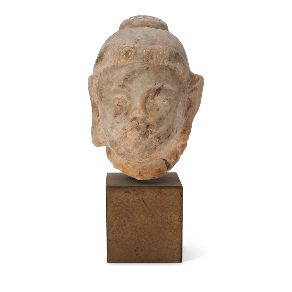A White Marble Head of Buddha China, Tang style,: A White Marble Head of Buddha China, Tang style, 4 1/8in (10.5cm) high Lot to be sold without reserve. This lot is subject to the following lot symbols: ¤ ¤ Unless indicated by the ¤ sy