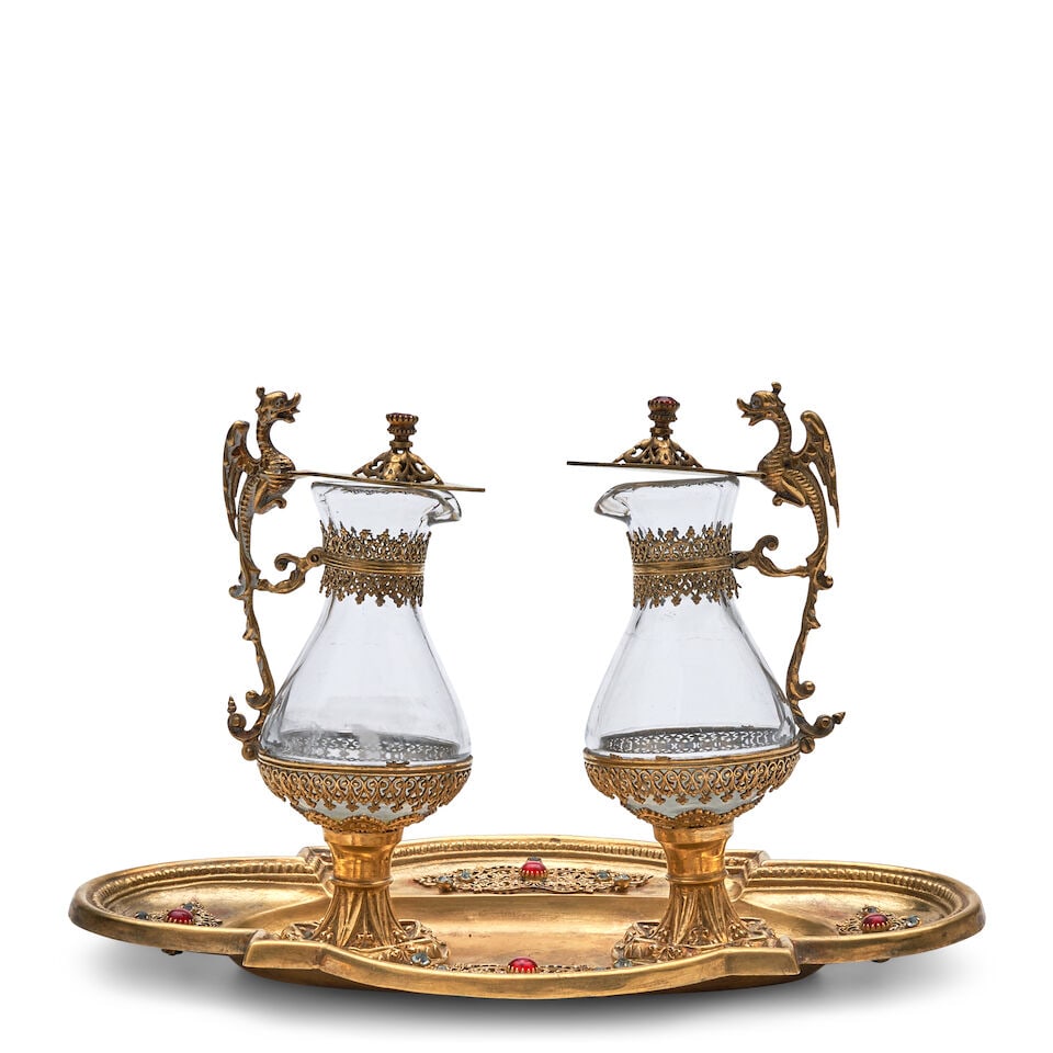 Jeweled Ormolu Cruet Set, 19th century,: Jeweled Ormolu Cruet Set, 19th century, an ovoid tray and two glass bottles adorned with paste stones and filigree motifs, each bottle with hinged lid and dragon-form handle, bottle ht. 6 3/4, tray