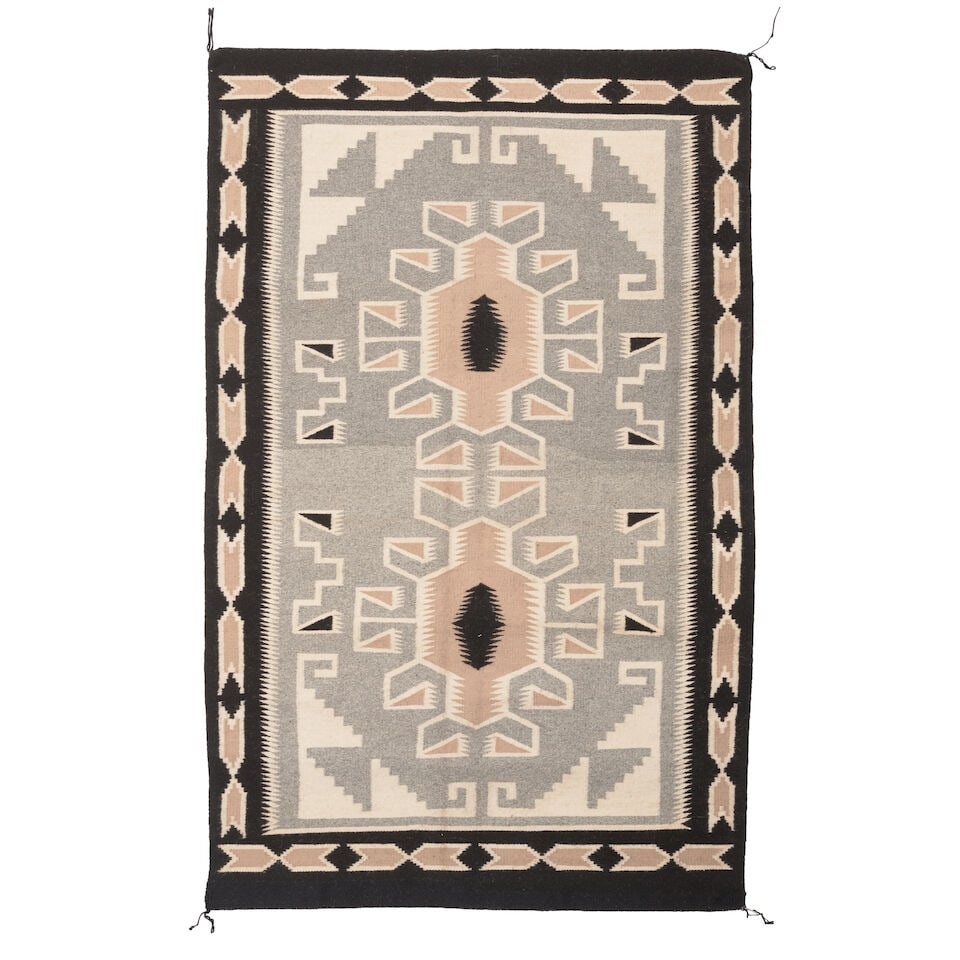 A Diné (Navajo) Two Grey Hills rug: A Diné (Navajo) Two Grey Hills rug With a pair of geometric medallions within a geometric border. size approximately 4ft 11in x 3ft 1/2in Lot to be sold without reserve. This lot is subject to