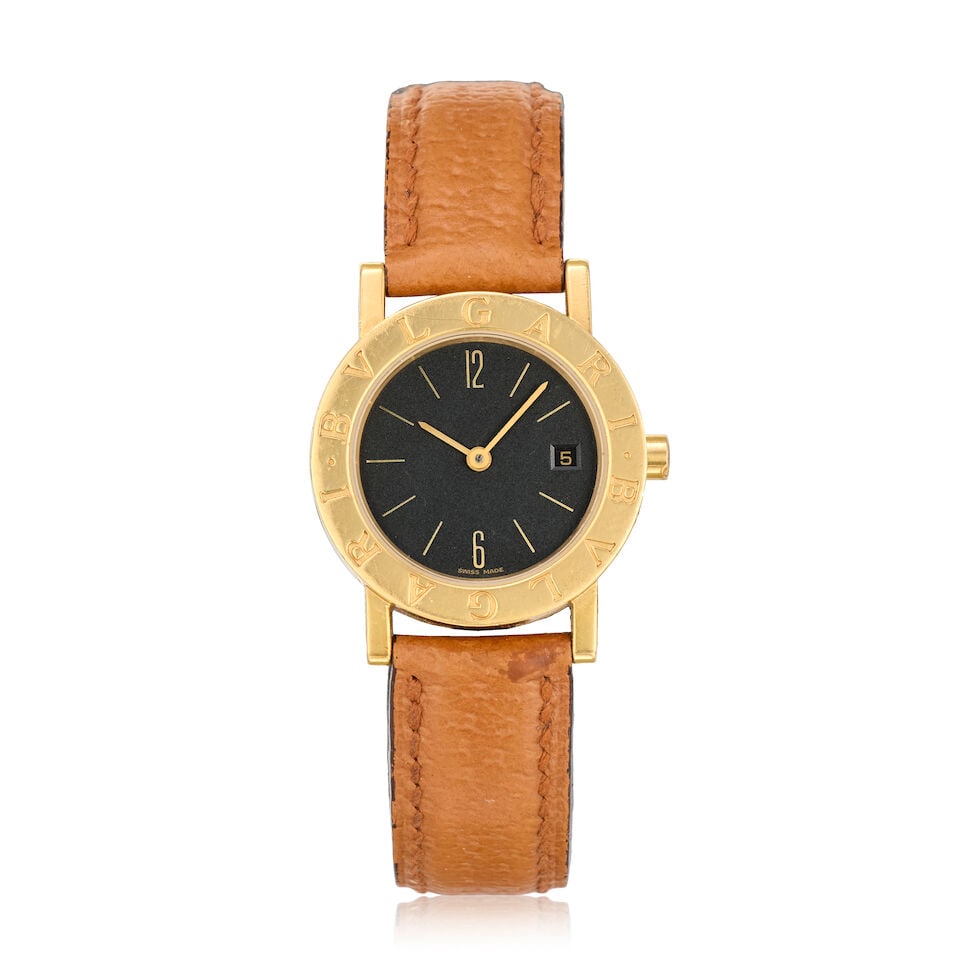 Bulgari. A lady's 18K gold quartz calendar wristwatch Ref: BB 26 GL, Circa 2001: Bulgari. A lady's 18K gold quartz calendar wristwatch Reference: BB 26 GL Date: Circa 2001 Movement: 8-jewel Cal.712-MBBE quartz Dial: Black, gilt baton hour markers, date aperture at 3 Case: Brushed 