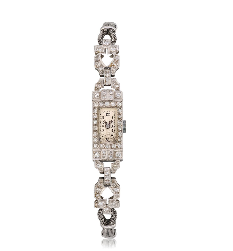 A lady's platinum and diamond set manual wind bracelet watch Circa 1920: A lady's platinum and diamond set manual wind bracelet watch Date: Circa 1920 Movement: 15-jewel manual wind Dial: Silvered Case: Engraved rectangular form, diamond set bezel, No.2499 Strap/Bracelet: