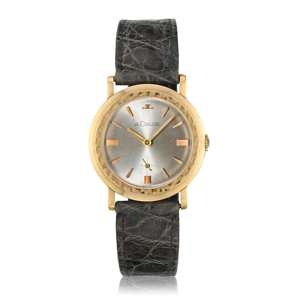 LeCoultre. A 14K gold manual wind wristwatch Ref: 485-893, Circa 1959: LeCoultre. A 14K gold manual wind wristwatch Reference: 485-893 Date: Circa 1959 Movement: 17-jewel Cal.K818/CW automatic, No.726113 Dial: Sunburst silvered Case: Brushed and polished round, textured