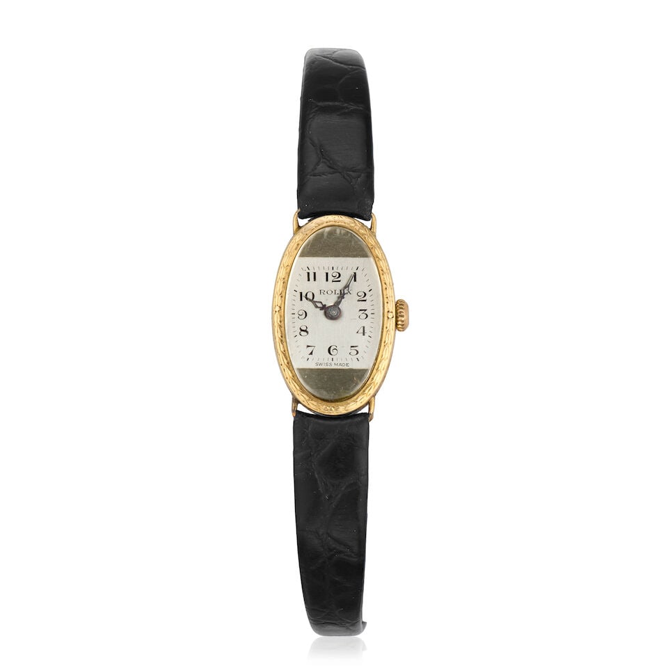 Rolex. A lady's 18K gold manual wind wristwatch Glasgow Import mark for 1924: Rolex. A lady's 18K gold manual wind wristwatch Date: Glasgow Import mark for 1924 Movement: 15-jewel Prima, timed 6 positions Dial: Two-tone silver-white, printed Arabic numerals Case: Engraved oval 