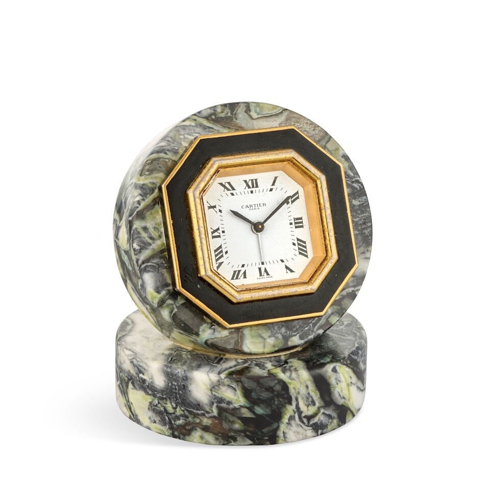 Cartier. A gilt and enamel desk clock with alarm in later marble mount Circa 1980: Cartier. A gilt and enamel desk clock with alarm in later marble mount Date: Circa 1980 Movement: Jewelled manual wind Dial: White Case: Brushed octagonal form with later non-Cartier round marble oute