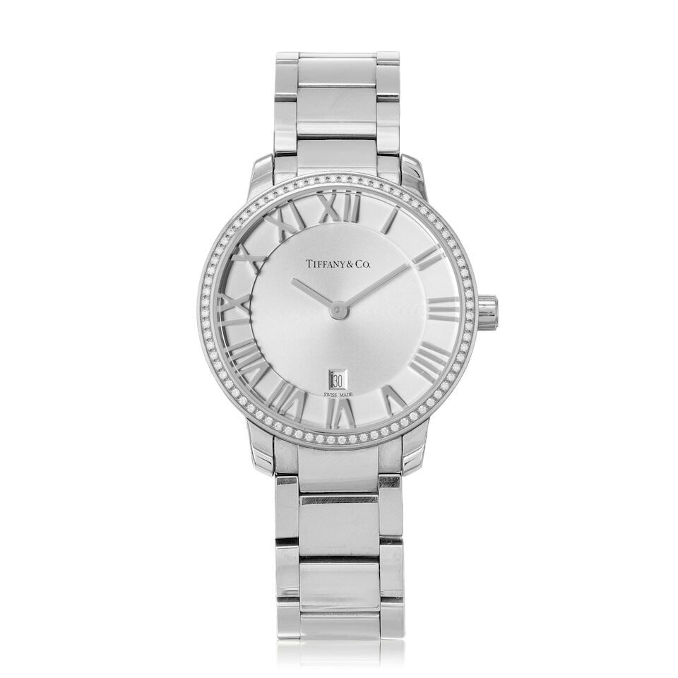 Tiffany & Co. A lady's stainless steel diamond-set quartz calendar bracelet watch Atlas, Circa 2010: Tiffany & Co. A lady's stainless steel diamond-set quartz calendar bracelet watch Model: Atlas Date: Circa 2010 Movement: 5-jewel Ronda cal.784 quartz Dial: Silvered, applied Roman numeral hour
