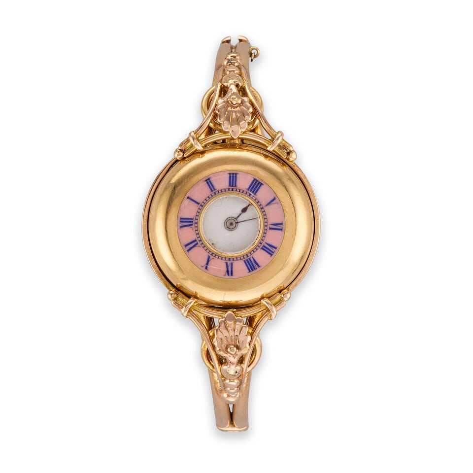 An 18K gold key wind half hunter pocket watch with later continental gold bangle Circa 1900: An 18K gold key wind half hunter pocket watch with later continental gold bangle Date: Circa 1900 Movement: Swiss lever Dial: White Case: Polished round, No.229743 Size: 27mm Accompaniments: