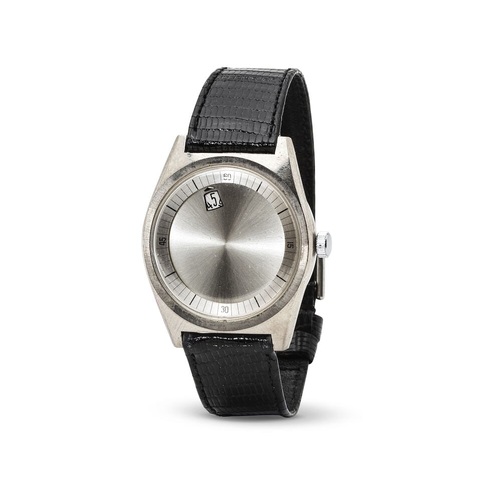 A metal manual wind wandering jump hour wristwatch Montre bracelet en métal avec heures sau...: A metal manual wind wandering jump hour wristwatch Montre bracelet en métal avec heures sautantes rotatives mouvement mécanique Date: Circa 1970 Movement: Jewelled A. Schild Cal.1690 manual