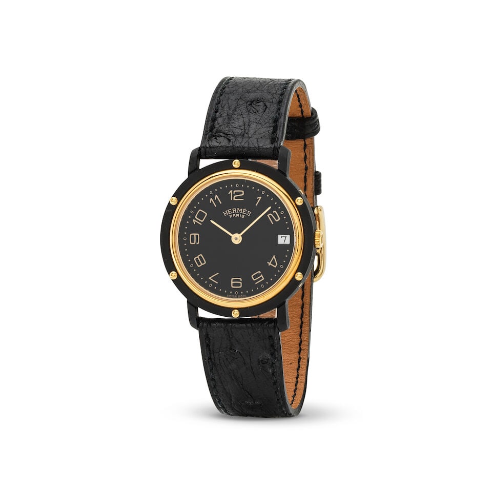 Hermès. A black DLC coated and gold plated quartz calendar wristwatch Hermès. Montre b...: Hermès. A black DLC coated and gold plated quartz calendar wristwatch Hermès. Montre bracelet en plaqué or et PVD noir avec date mouvement quartz Model: Clipper Date: Circa
