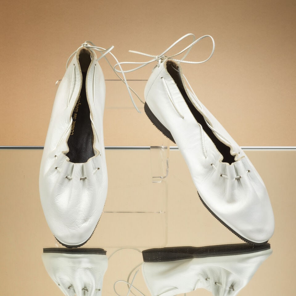 Comme des Garçons, Printemps-Eté 1982. Paire de ballerines en cuir blanc, laçage ...: Comme des Garçons, Printemps-Eté 1982. Paire de ballerines en cuir blanc, laçage dos. Comme des Garçons, Spring-Summer 1982. Pair of white leather ballerina flats with back lacing.