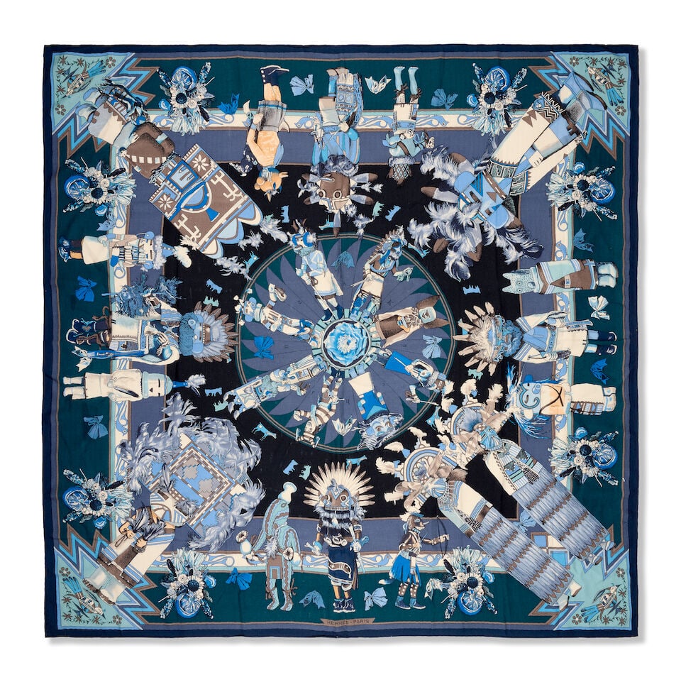 Hermès: a Kachinas Cashmere and Silk Scarf 140 c.2012, designed by Kermit Oliver: Hermès: a Kachinas Cashmere and Silk Scarf 140 c.2012, designed by Kermit Oliver In shades of blue 70% cashmere, 30% silk Condition Grade B+ 140cm x 140cm For further information on this lot plea