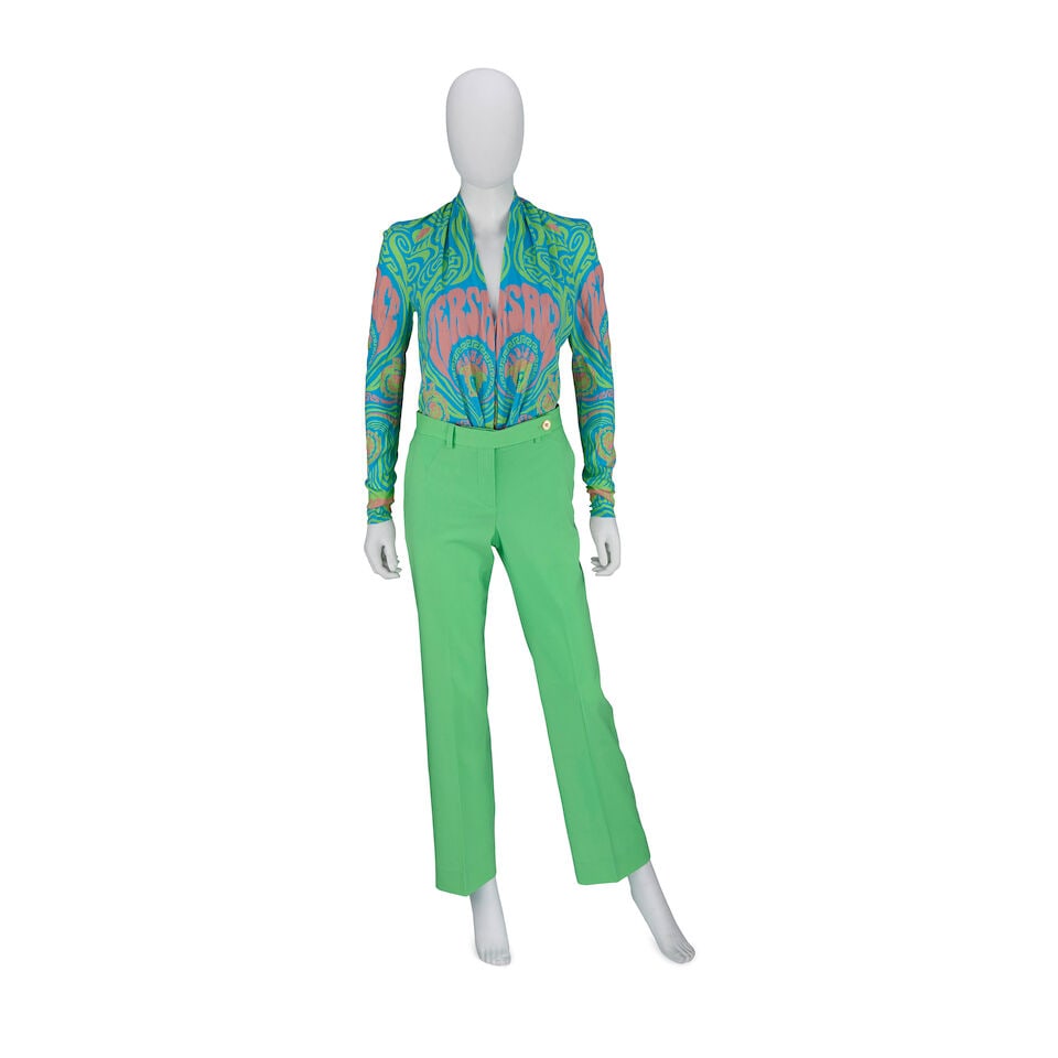 Versace: a Medusa Music Long Sleeve Bodysuit and Green Trousers (Trousers with original tags): Versace: a Medusa Music Long Sleeve Bodysuit and Green Trousers Creative Director: Donatella Versace Green and blue printed crepe body suit, paired with neon green wool trousers with Medusa head butto
