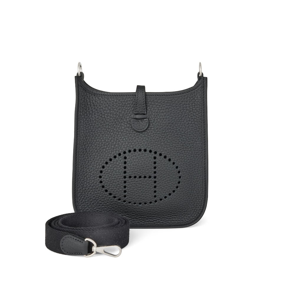 Hermès: a Black Clemence Leather Evelyne TPM 16 2025 (includes dust bags, care card and box): Hermès: a Black Clemence Leather Evelyne TPM 16 2025 Black canvas strap and palladium hardware Condition Grade A+ 16cm wide, 18cm high, 55cm shoulder drop, includes dust bags, care card and box F