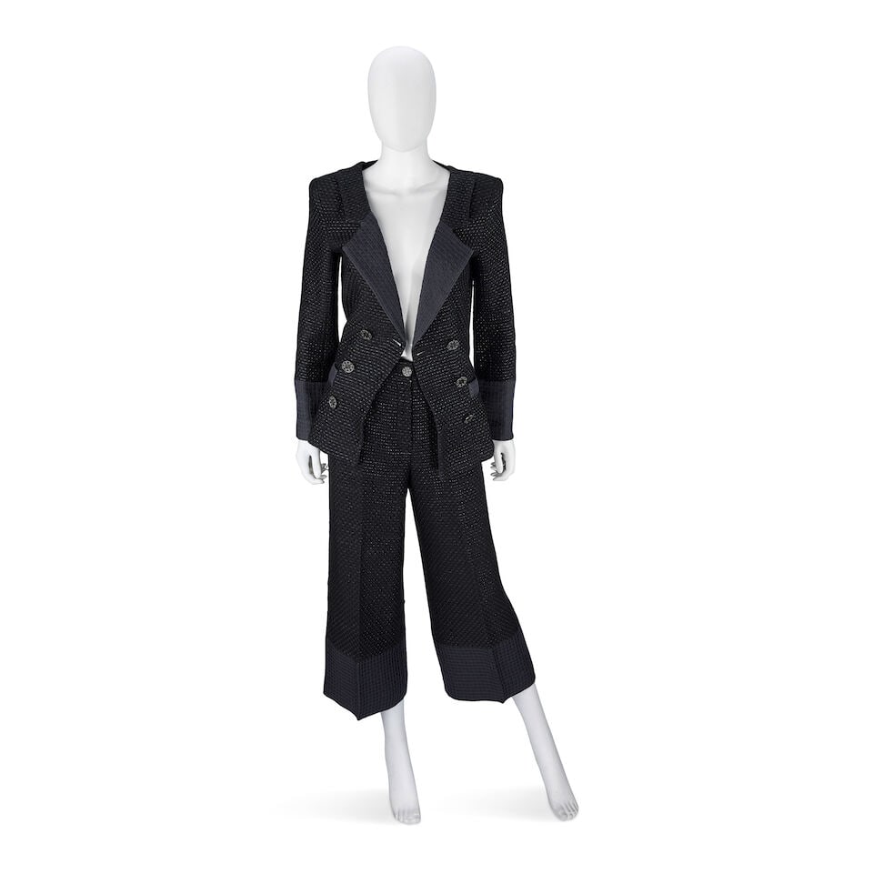 Chanel: a Black Cotton Blend Trouser Suit Paris-Seoul Collection, Cruise 2016, Runway Look 52: Chanel: a Black Cotton Blend Trouser Suit Paris-Seoul Collection, Cruise 2016, Runway Look 52 Creative Director: Karl Lagerfeld Woven black cotton with contrasting lapels and cuffs in dark mauve stitc