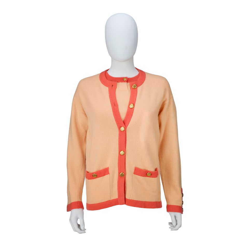 Chanel: a Coral and Orange Cashmere Twinset: Chanel: a Coral and Orange Cashmere Twinset Creative Director: Karl Lagerfeld Beige/coral knitted cashmere with orange trim with gold tone CC buttons, comprising a long sleeve cardigan and a short sle