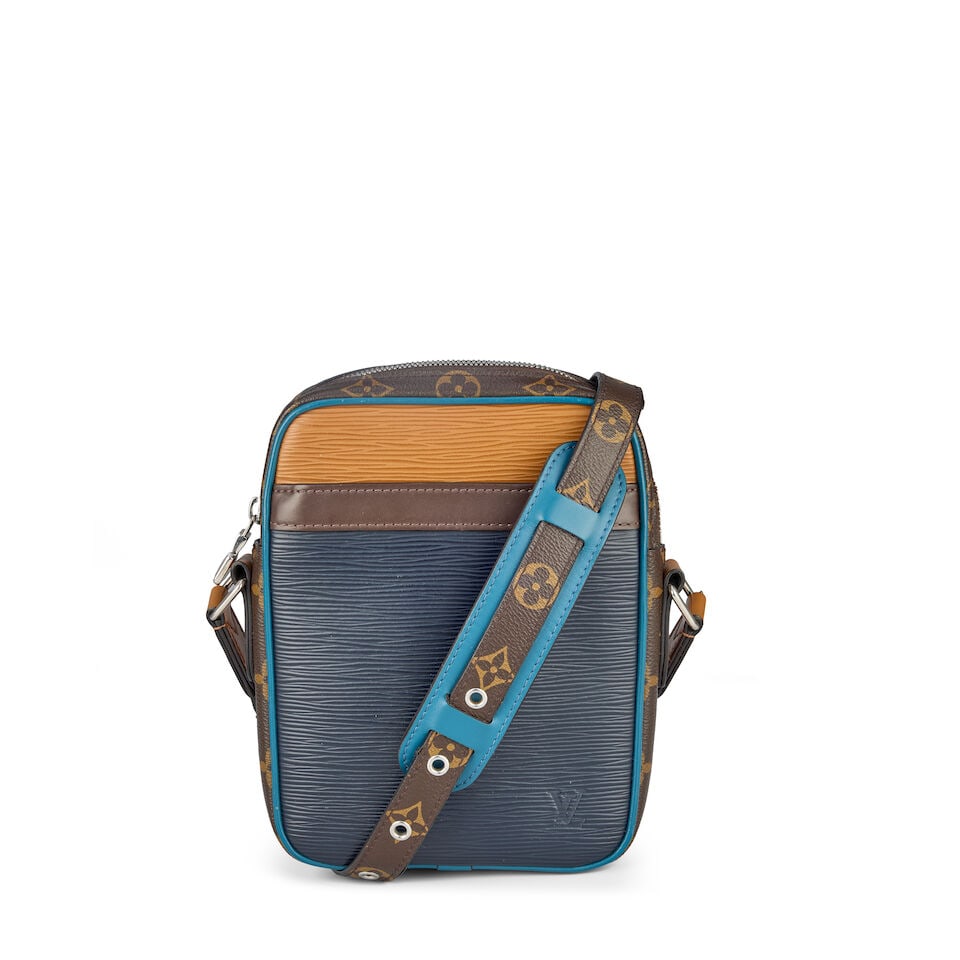 Louis Vuitton: an Epi Leather Slim Danube Shoulder Bag 2018 (includes box): Louis Vuitton: an Epi Leather Slim Danube Shoulder Bag 2018 Creative Director: Virgil Abloh Dark blue, caramel, and brown epi leather panels, with monogram canvas trim, silver tone hardware Condition 
