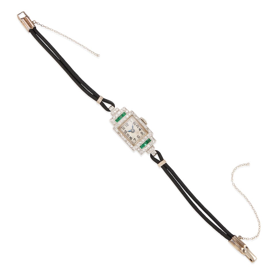 ART DECO PALLADIUM, GOLD, DIAMOND, AND EMERALD WATCH: ART DECO PALLADIUM, GOLD, DIAMOND, AND EMERALD WATCH •Palladium, 14k white gold •Numerous round single diamonds weighing approximately 0.50 - 0.60 carats total •6 square emeralds