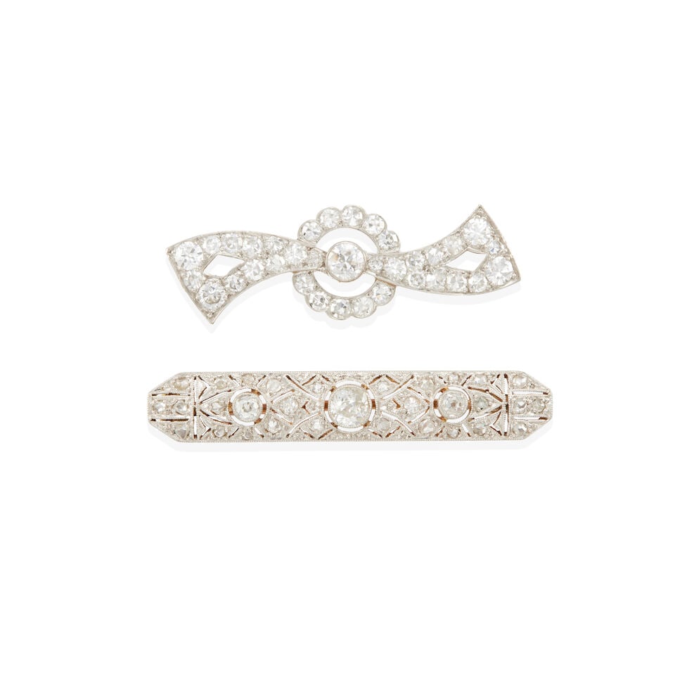 TWO ANTIQUE PLATINUM, PLATINUM TOPPED 14K GOLD, AND DIAMOND BROOCHES: TWO ANTIQUE PLATINUM, PLATINUM TOPPED 14K GOLD, AND DIAMOND BROOCHES •Art Deco platinum brooch with numerous round single diamonds weighing approximately 1.15 - 1.20 carats total, length: 1