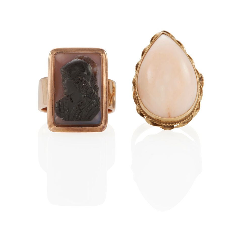 TWO VINTAGE GOLD, CORAL, AND SARDONYX RINGS: TWO VINTAGE GOLD, CORAL, AND SARDONYX RINGS •14k yellow gold ring with 1 pear shape cabochon coral measuring approximately 21.40 x 14.32 x 7.53 mm, size: 4 ¾ •10k pink gold ring with