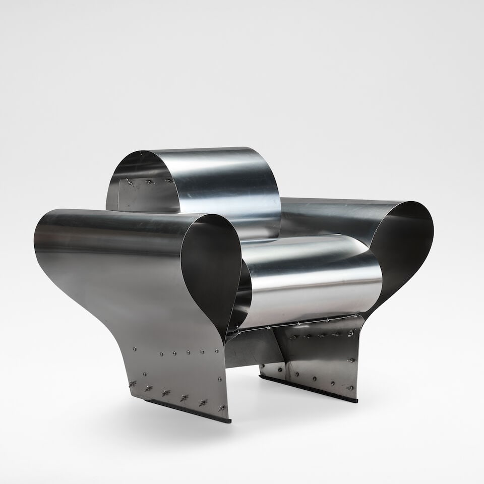 Ron Arad 'Well Tempered Chair', designed 1986: Ron Arad 'Well Tempered Chair', designed 1986 Stainless steel and wingnuts, of four piece construction. 76 cm high, 92 cm wide, 76 cm deep Manufactured by Vitra. This lot is subject to the following