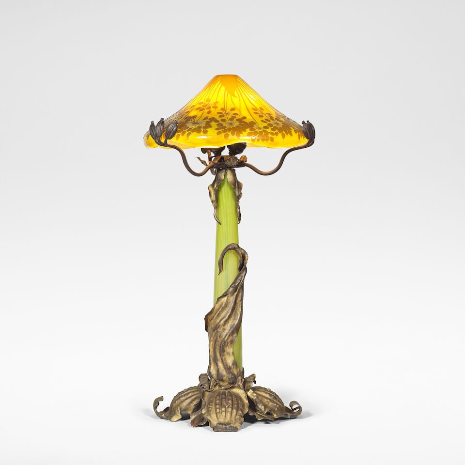 Emile Gallé 'Umbel' table lamp, circa 1900: Emile Gallé 'Umbel' table lamp, circa 1900 Cased glass with cameo shade, with wrought and partially gilt iron mounts. 76 cm high, 40 cm diameter Shade signed in cameo GALLÉ. Footnotes: Liter