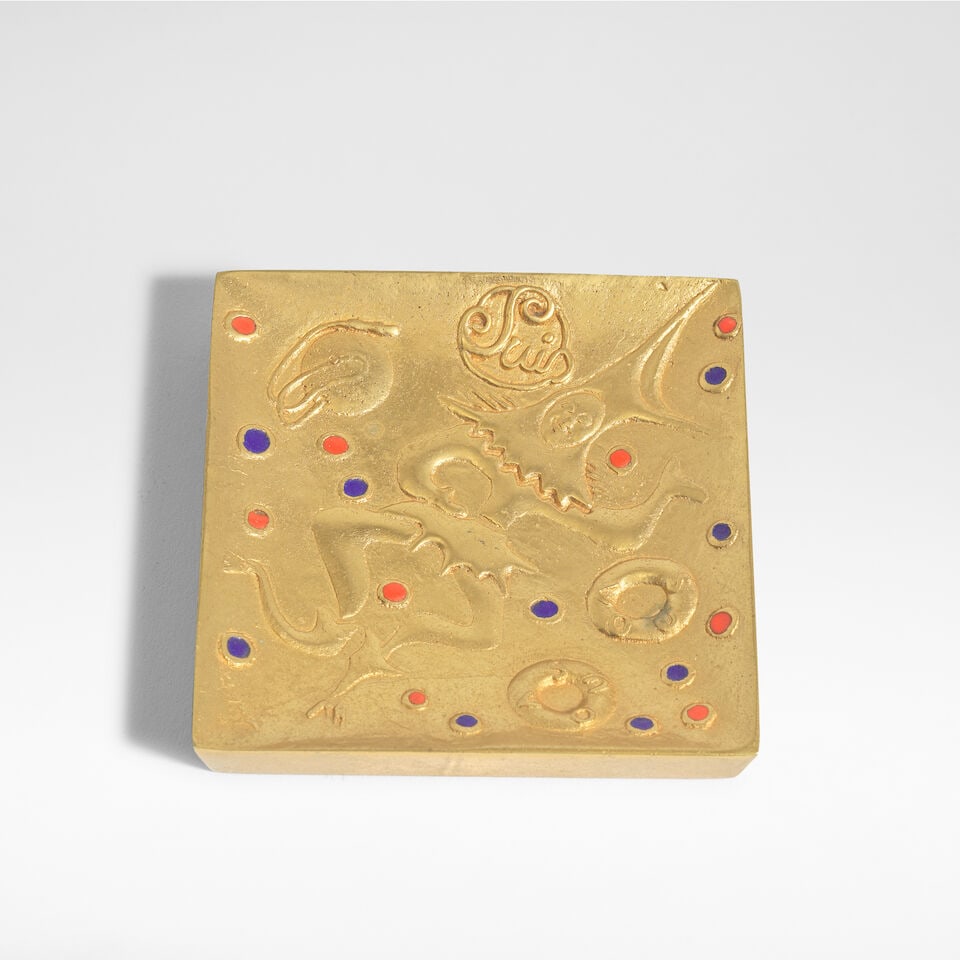 Line Vautrin 'Je suis fou de vous' vide-poche, circa 1950: Line Vautrin 'Je suis fou de vous' vide-poche, circa 1950 Gilt-bronze, modelled in relief with a jester and the words 'suis' and 'vous' twice, with blue and orange enamel. 7.6 cm square, 1.2 cm
