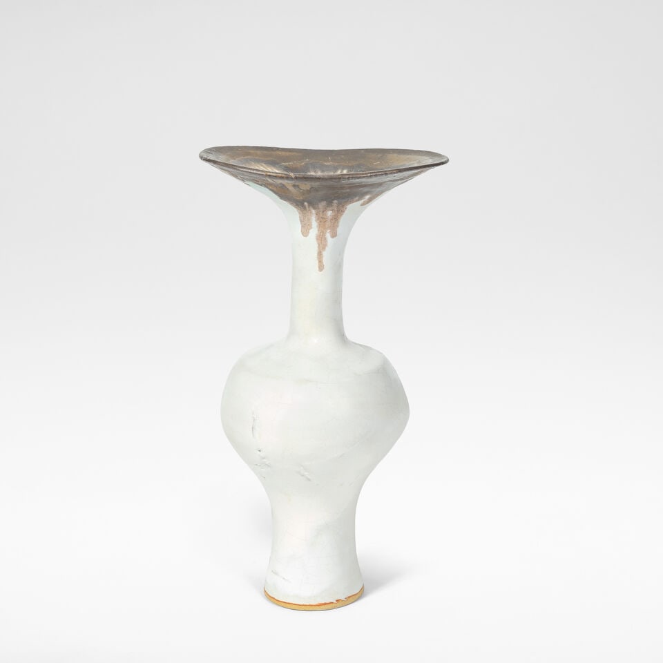 Lucie Rie Flared vase, circa 1980: Lucie Rie Flared vase, circa 1980 Stoneware, white glaze, feathered golden manganese rim with a soft turquoise hue to edges. 24.8 cm high, 13.3 cm wide, 10.2 cm diameter Underside impressed with