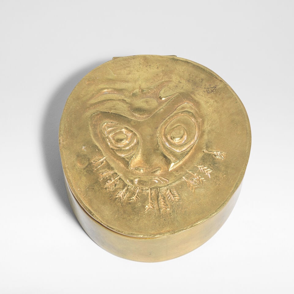 Line Vautrin 'Le lion' boîte, circa 1950: Line Vautrin 'Le lion' boîte, circa 1950 Gilt-bronze, cork to interior, lid modelled with an abstract lion's face with arrows. 9.8 cm wide, 11 cm deep, 3.2 cm high Underside stamped LINE VAUTRIN.