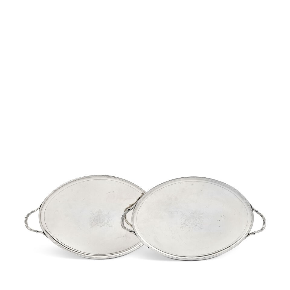 A pair of George III oval silver two-handled trays John Crouch & Thomas Hannam, London 1789 and ...: A pair of George III oval silver two-handled trays John Crouch & Thomas Hannam, London 1789 and 1790 With reeded borders and the loop handles with leaf junctions, the centres engraved with the Royal c