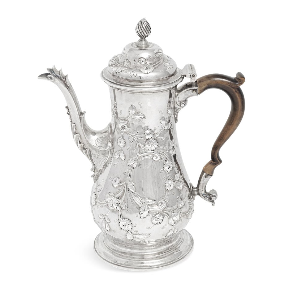 A George III silver coffee pot Samuel Whitford I, London 1764: A George III silver coffee pot Samuel Whitford I, London 1764 Baluster form, the hinged dome cover with wrythen finial, chased with trailing flowers, scroll cartouche either side, wood scroll handle, 